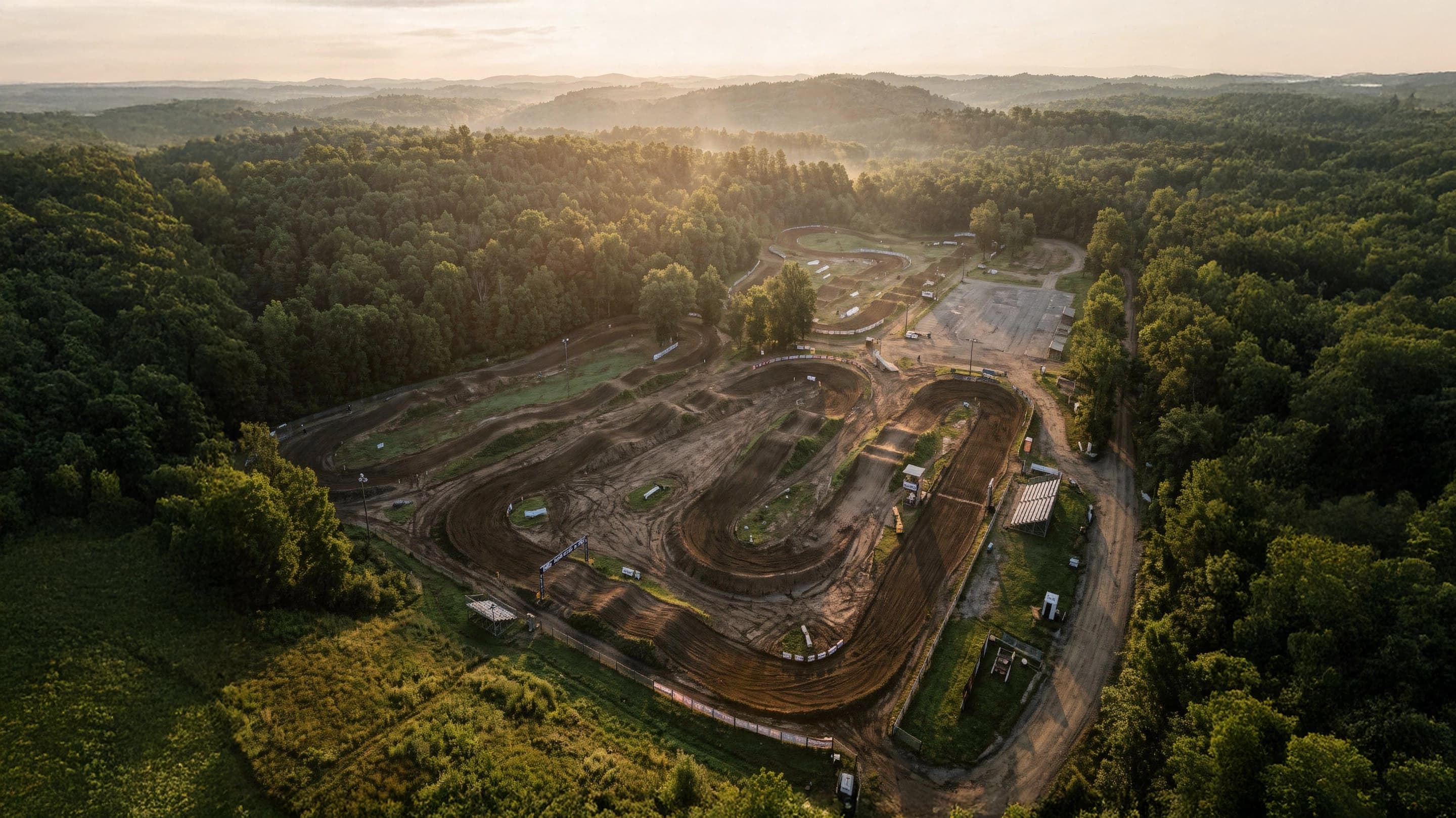 An aerial view of a well-kept motocross track in the woods